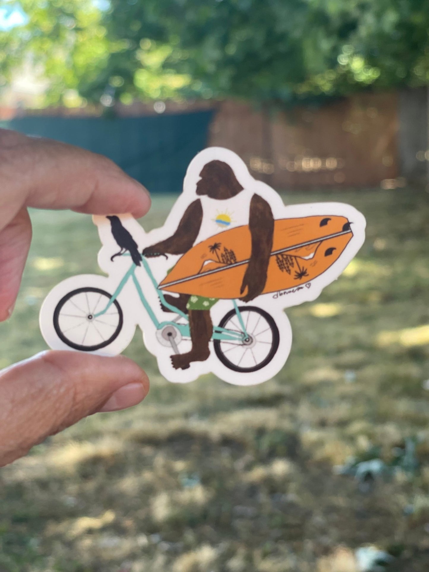 Bigfoot on Bike with Surfboard & Crow – Matte Die Cut Sticker - Color Crumbs Club