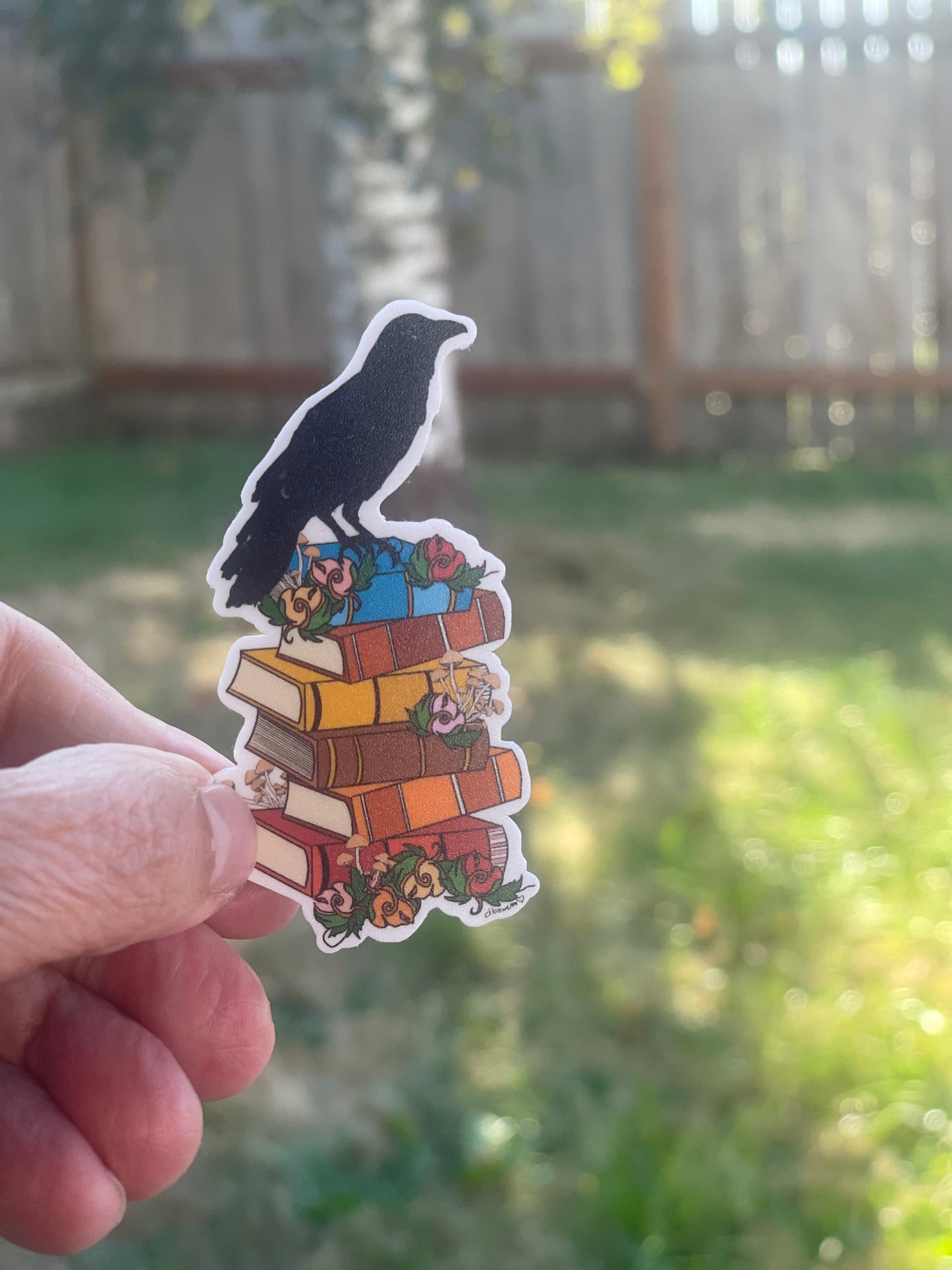 Crow on Stack of Books Sticker – Whimsical Literary Design