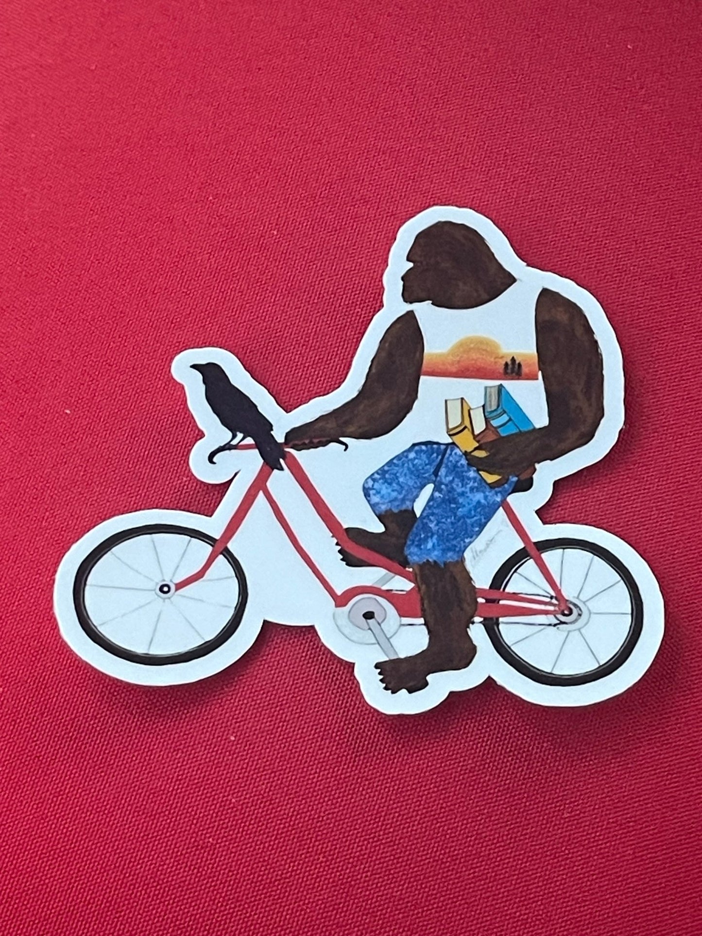 Bigfoot with books on bike with Crow – Whimsical Sasquatch Vinyl Decal Die Cut Sticker - Color Crumbs Club