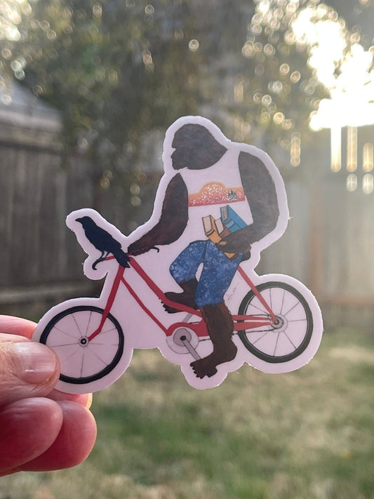 Bigfoot with books on bike with Crow – Whimsical Sasquatch Vinyl Decal Die Cut Sticker - Color Crumbs Club